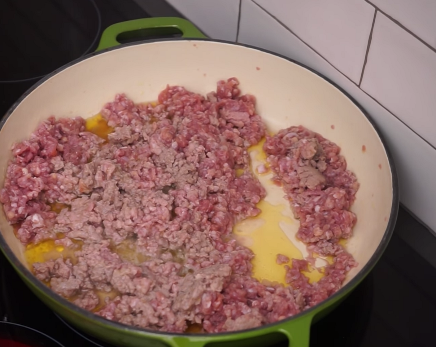step 6 Add the Ground Pork (9 oz) and Ground Veal (9 oz) mince into the pan and let it start to brown while you break it down and spread it out into smaller pieces using a wooden spoon
