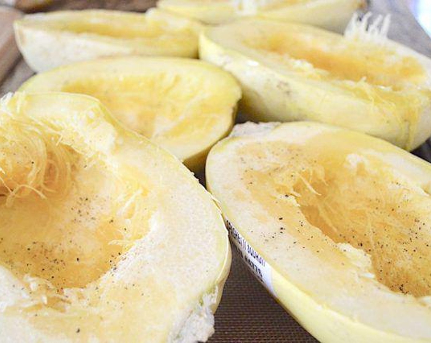 step 3 Cut the spaghetti squash in half and line them up on the sheet tray. Drizzle each half generously with Olive Oil (as needed) and sprinkle them with lots of Salt (to taste) and Ground Black Pepper (to taste). Place the tray in the oven to roast the squash for 45 minutes.