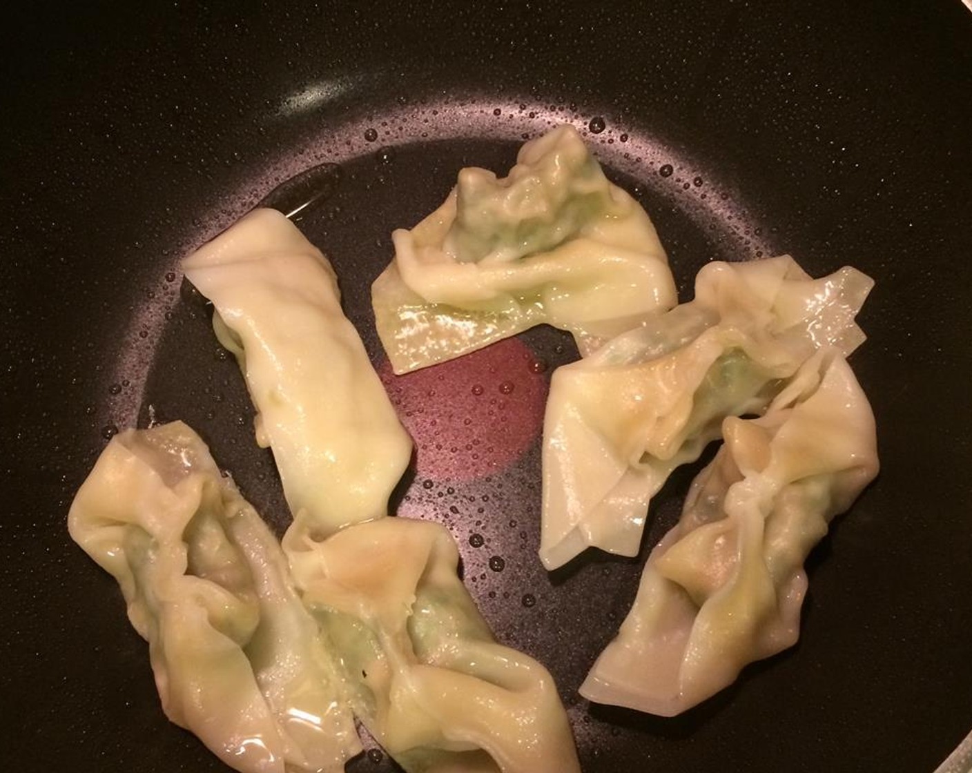 step 10 Add Vegetable Oil (2 Tbsp) to a pan over medium heat. Pan-fry the dumplings for about 5 minutes. Do not crowd the pan. Turn over once in a while using chopsticks.