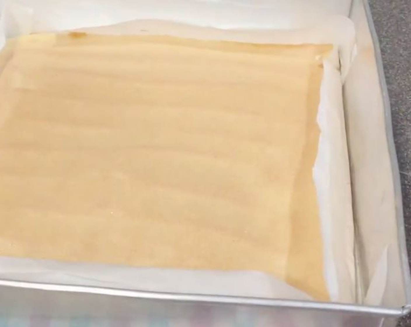 step 16 Bake in a preheated oven for 25 minutes. Let it cool before removing from the parchment paper. Trim off the sides but don't throw them away.