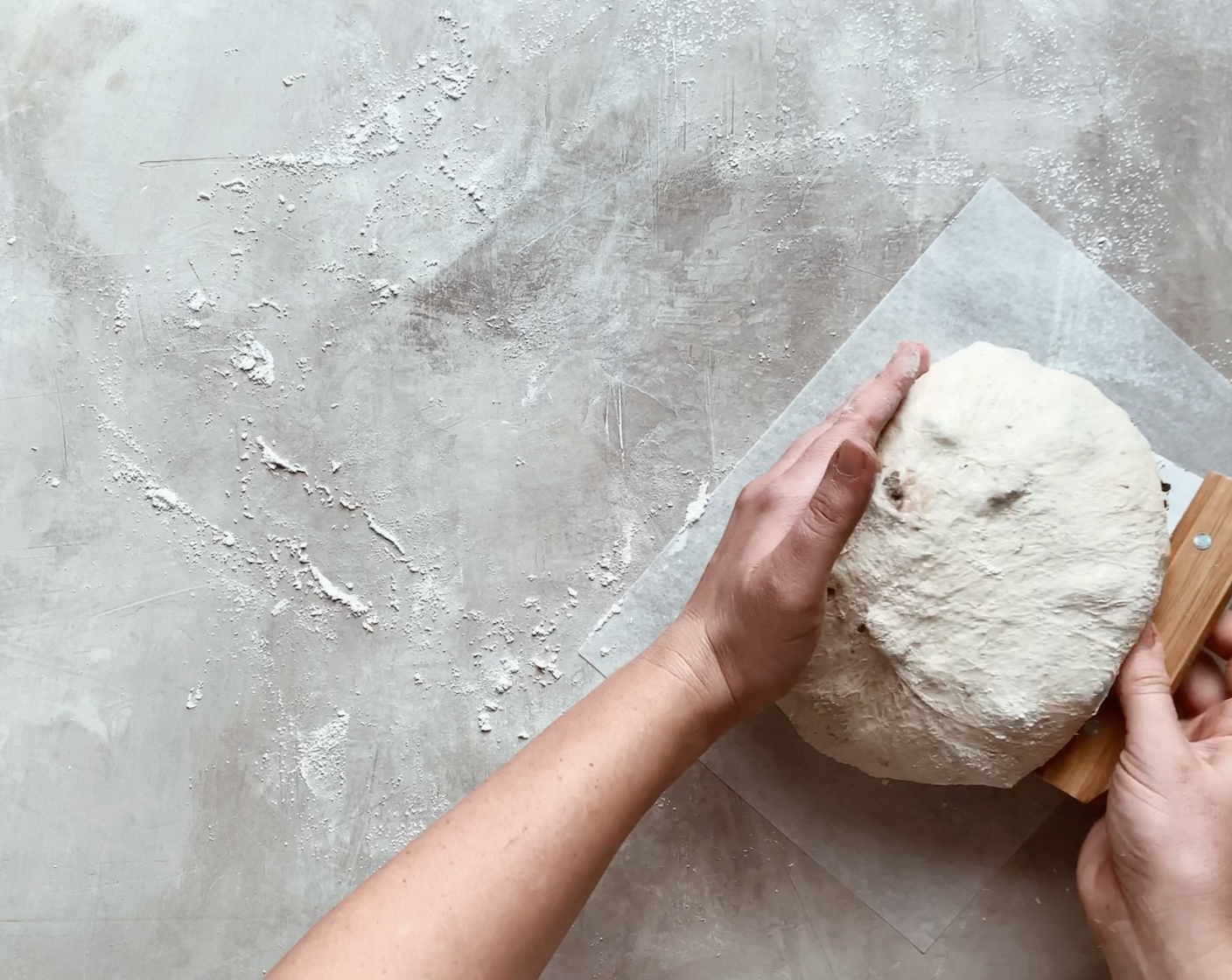 step 10 Transfer the dough round, seam side down, onto a sheet of parchment paper.