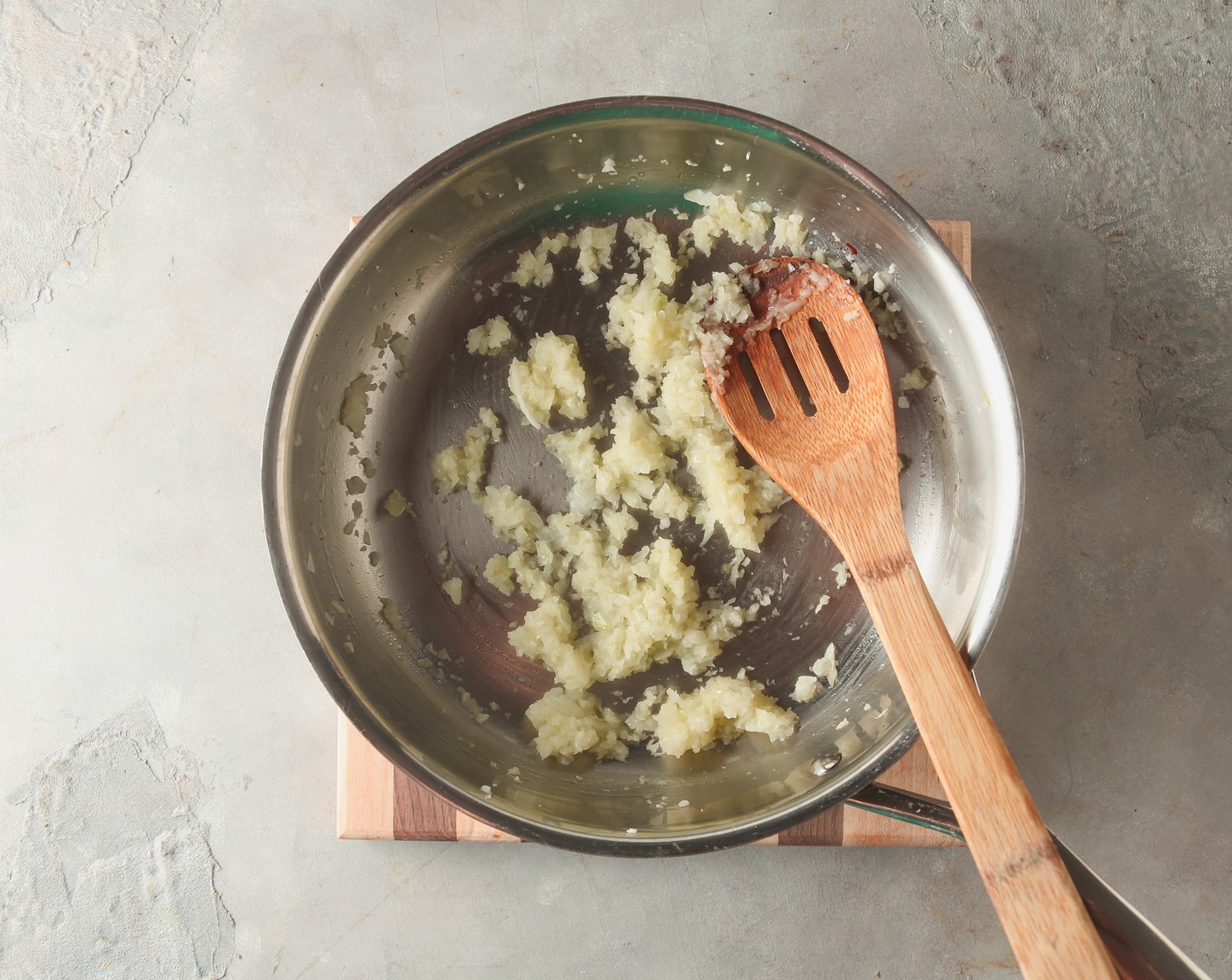 step 3 Meanwhile, heat the Vegetable Oil (1 Tbsp) in a skillet. When the oil is shimmering, add the Onion (1) and Garlic (2 cloves). Cook for 2-3 minutes, until translucent.