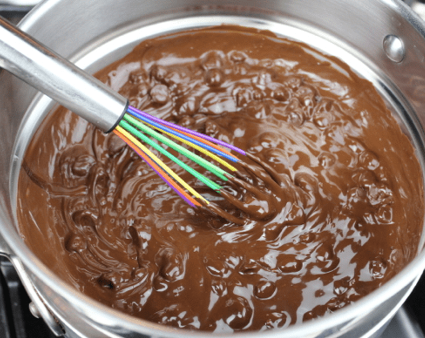 step 2 Occasionally stir the chocolate with a whisk to help in melting the chocolate. Once the chocolate is completely melted, remove the upper pan from the double boiler and set it on your counter.