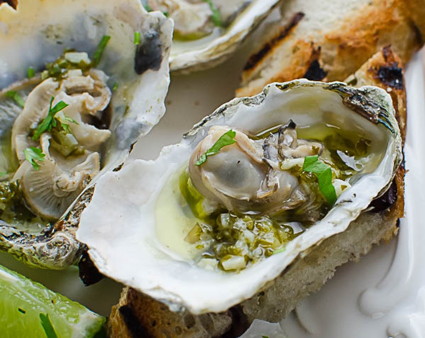 step 8 Discard the flat part of the shell. Arrange the oysters on a platter and spoon one teaspoon of the butter sauce over each oyster.