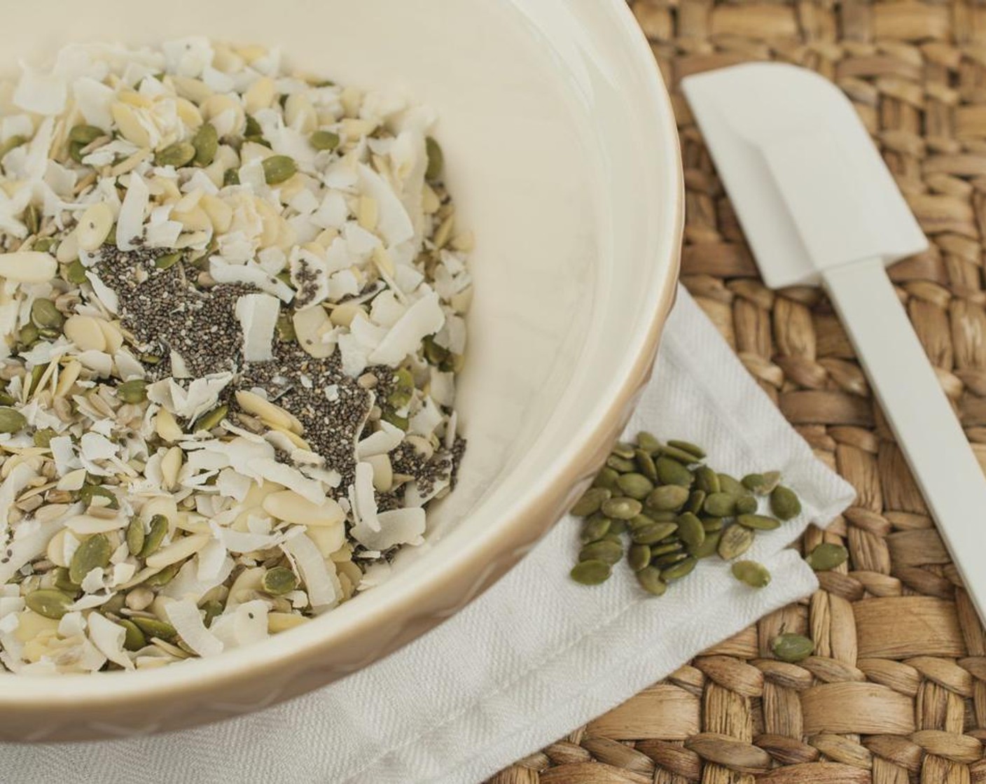 step 2 Add Unsweetened Coconut Flakes (2 cups), Sliced Almonds (1 cup), Pepitas (3/4 cup), Sunflower Seeds (1/2 cup), Chia Seeds (3 Tbsp), and Salt (1 pinch) to a large bowl. Drizzle with Corn Syrup (3/4 cup) toss gently to fully combine.