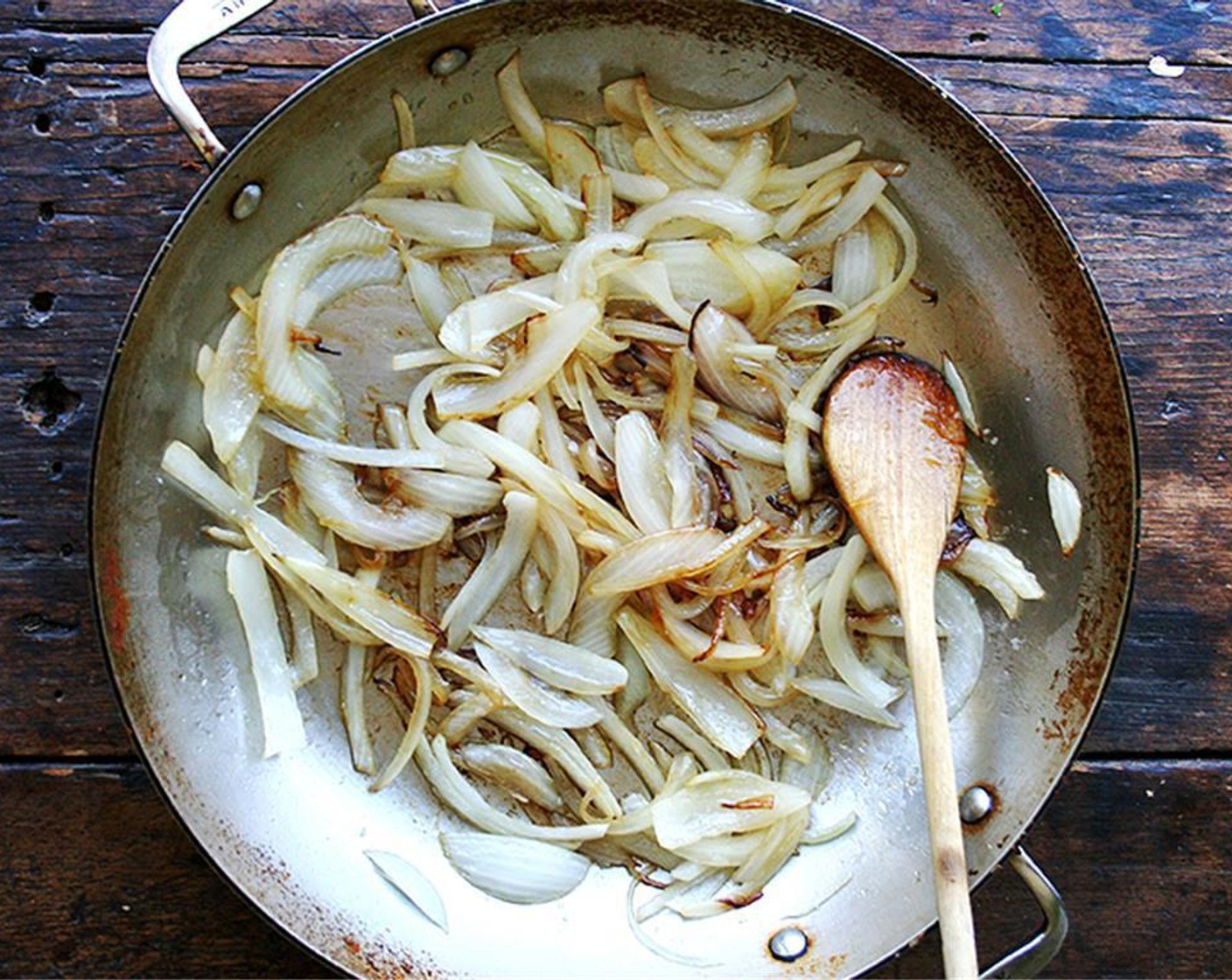 step 3 In a large sauté pan or pot, add the Olive Oil (2 Tbsp)  and place over medium heat. Add the sliced onion to the pan with a pinch of Kosher Salt (to taste) and sauté over medium heat until translucent or lightly brown, taking around about 5 minutes.