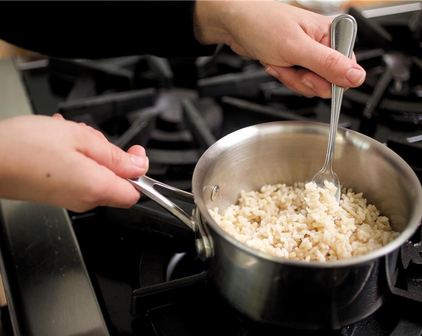 step 2 Remove the pot from heat, fluff rice, cover and set aside.