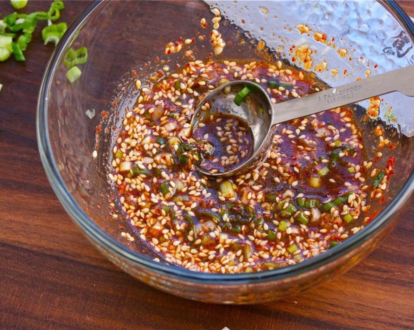 step 6 To make the sauce, mix Low-Sodium Soy Sauce (3 Tbsp), Korean Chili Flakes (1 tsp), Scallion, Garlic, Shrimp Powder (1/2 tsp), Sesame Oil (1 tsp), Roasted Sesame Seeds (1 tsp), and Salt (to taste) in a small mixing bowl.