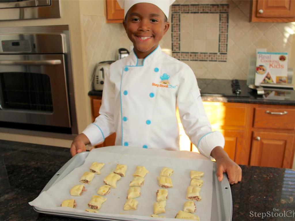 Step 7 of Sausage Bites With Maple Lemon Sauce Recipe: Make the egg wash by beating Organic Egg (1) and Water (1 tablespoon). Place on baking sheet and brush the rolls with the egg wash. Poke holes in the middle of the small rolls to prevent over puffing. Bake for 15 to 20 minutes, until puffed and golden brown.