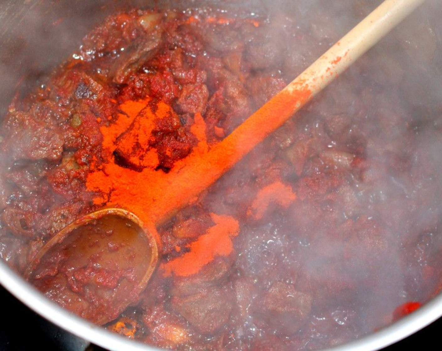 step 6 Next, add a generous amount of Paprika (to taste), Demi-Glace (4 cups), and Beef Stock (4 cups). Simmer until the beef is tender. This will take a while, around an hour depending on the cut of beef.