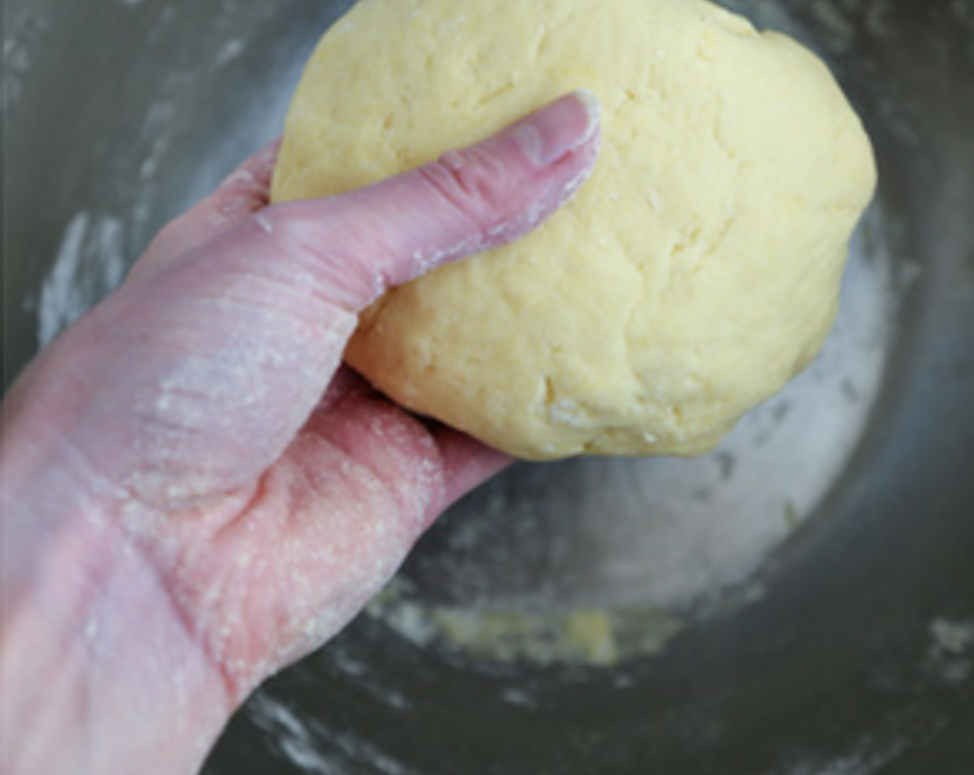 step 2 With clean hands, knead the dough in the bowl, pushing down and folding the patty back on itself until you have a ball that is more or less smooth in texture.