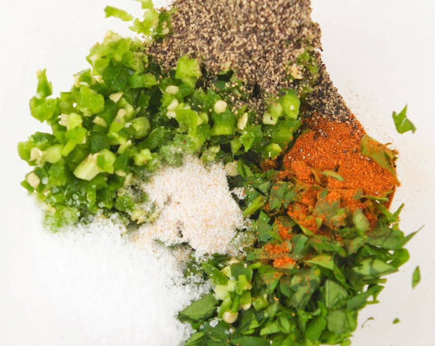 step 4 In a small bowl, combine the flat leaf parsley, jalapeno pepper, Kosher Salt (1 tsp), Garlic Salt (1/4 tsp), Freshly Ground Black Pepper (1/2 tsp), Cayenne Pepper (1/4 tsp), Extra-Virgin Olive Oil (4 Tbsp)