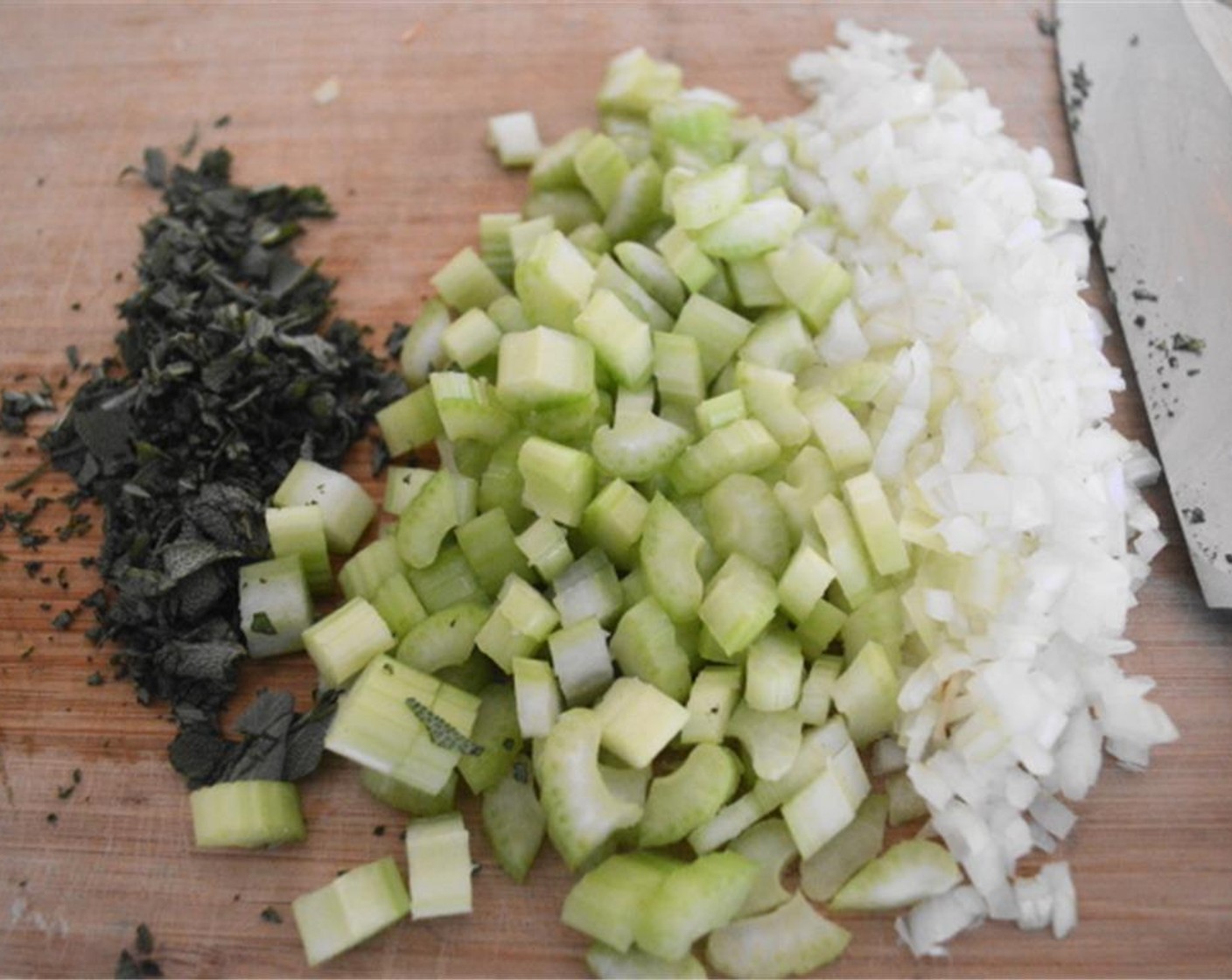 step 4 Once it is brown, add the Celery (4 stalks), Onion (1), and Sage Leaves (4 Tbsp) and let them get fragrant for just a minute.