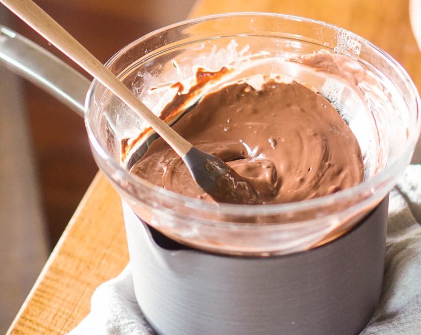 step 4 Add the half of Dark Chocolate Chips (2 cups) to the bowl with Coconut Oil (1 Tbsp). Stir with a rubber spatula until melted.