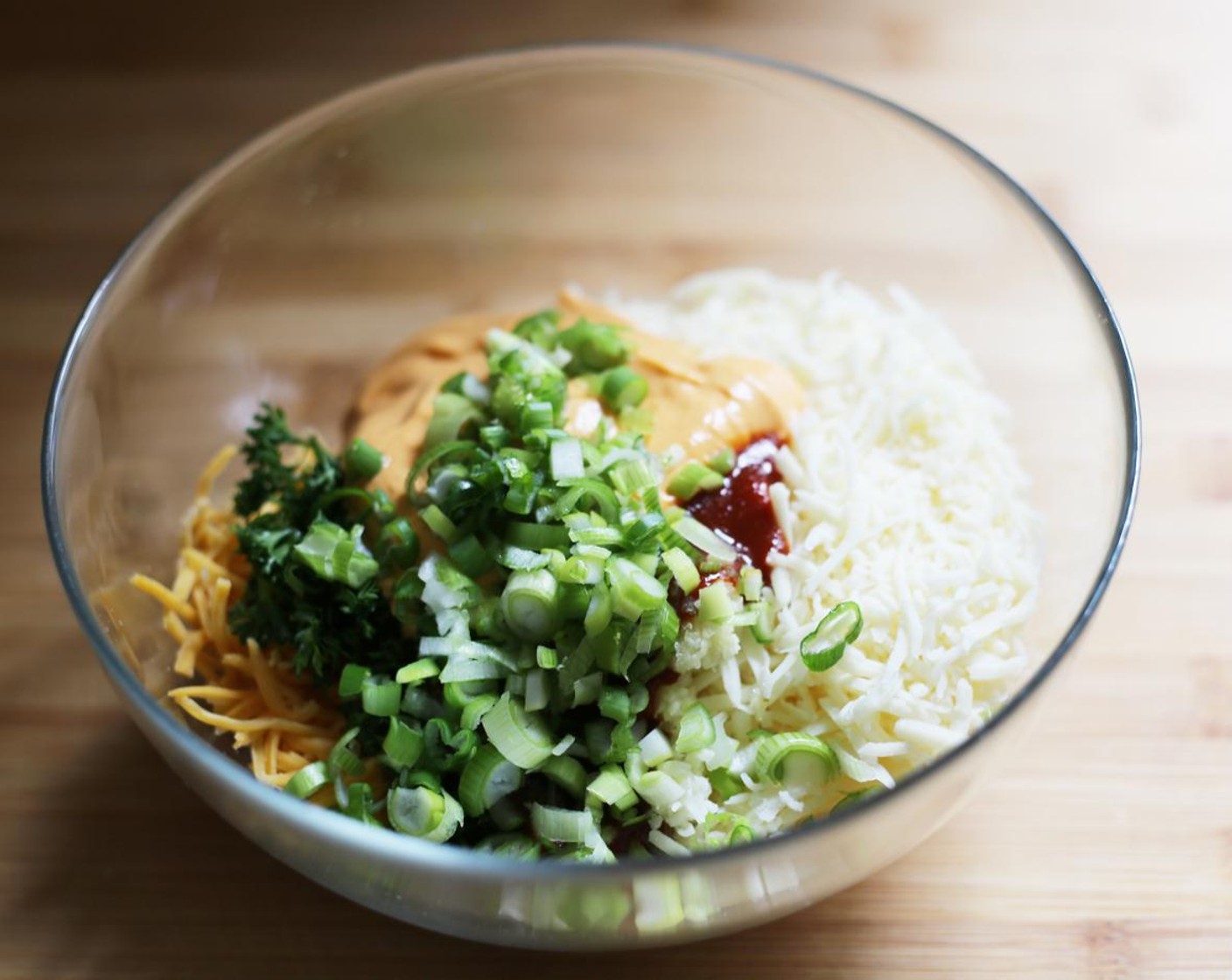 step 6 Add the Chung Jung One® Spicy Miso Sauce (2 Tbsp), 2 tablespoons of the Gochujang Aioli, and the Scallions (2 Tbsp).