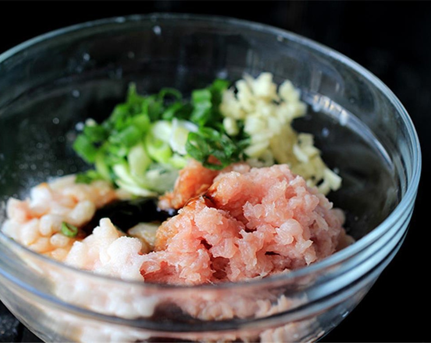 step 1 To make the filling, combine the Ground Pork (1 cup), Scallions (2 Tbsp), Fresh Ginger (1/2 Tbsp), Egg (1), Shrimp (1/2 cup), Ground Black Pepper (1/2 tsp), Sesame Oil (1/2 tsp), Oyster Sauce (1 Tbsp) and Salt (to taste).