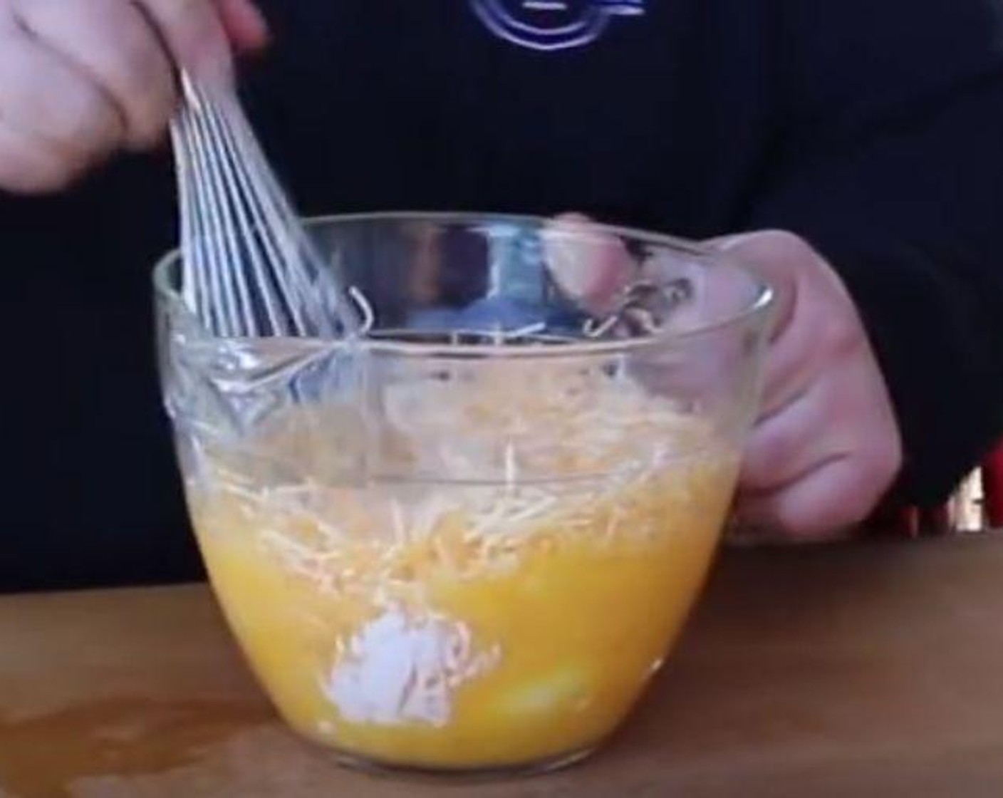 step 4 In a large mixing bowl, crack Farmhouse Eggs® Large Brown Eggs (10) and whisk. Add Shredded Cheese (2 cups), Sour Cream (1 cup), Hot Sauce (1 Tbsp) and a pinch of Salt (to taste) and Ground Black Pepper (to taste). Whisk to combine.
