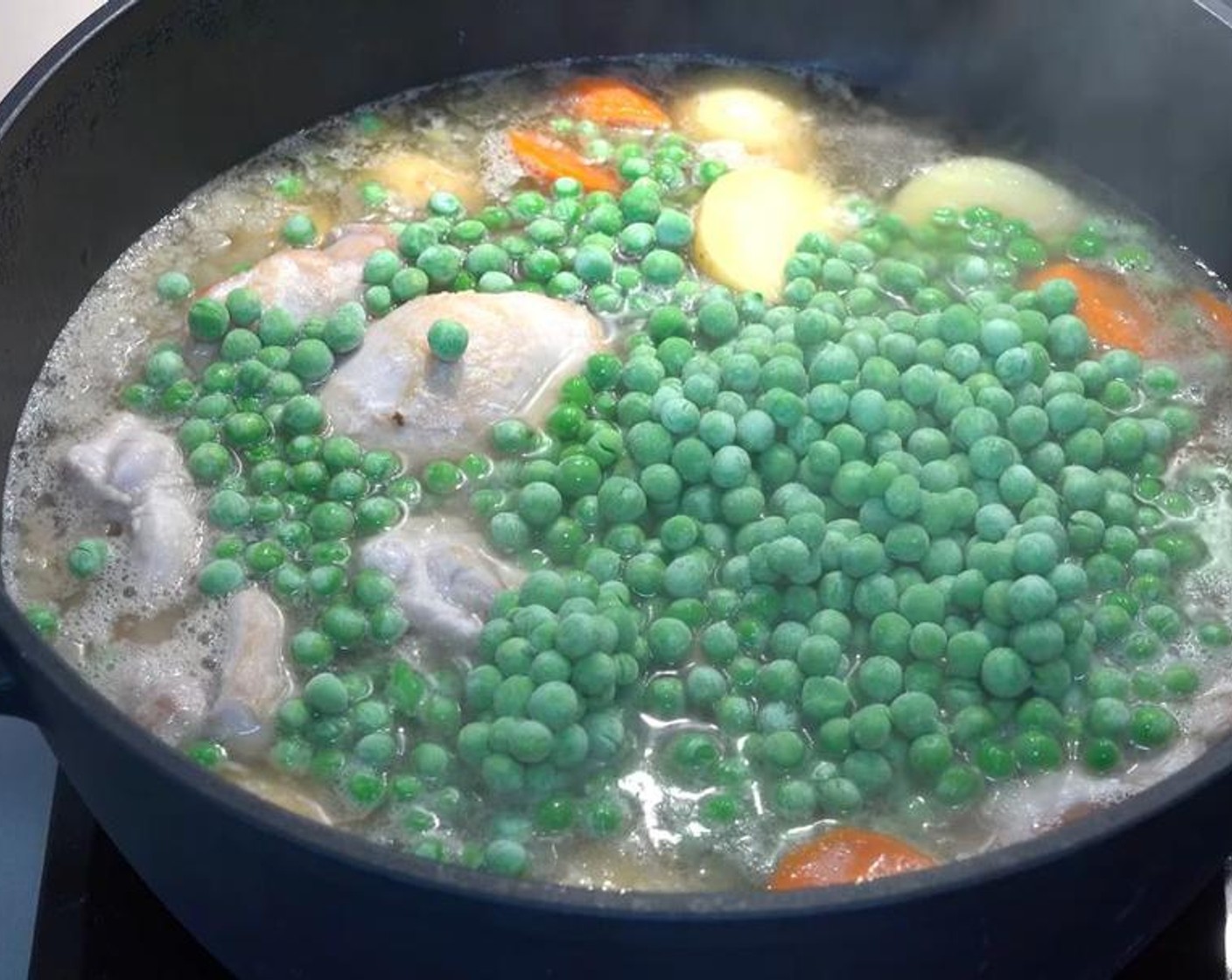 step 5 Add Frozen Green Peas (2 cups) and stir through. Cover and simmer for another 5-10 minutes, or until the chicken is cooked through and the vegetables are tender.