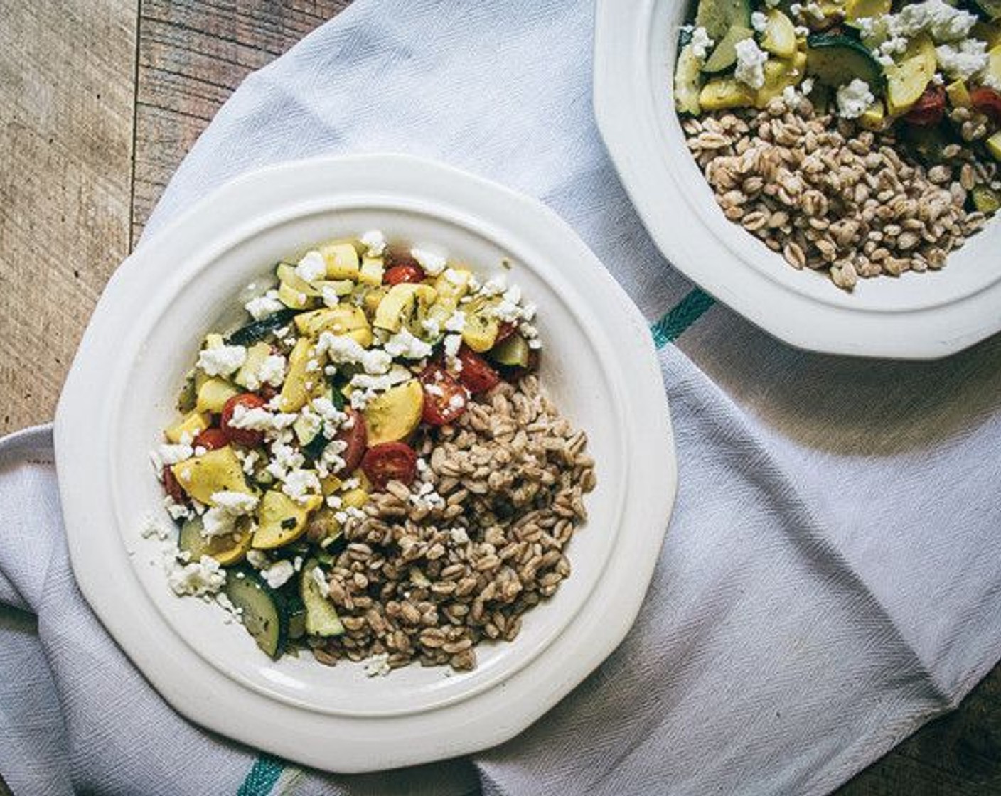 step 7 Once farro has cooked, divide evenly between two bowls, then dish out the cooked veggies and top with Feta Cheese (2 Tbsp).