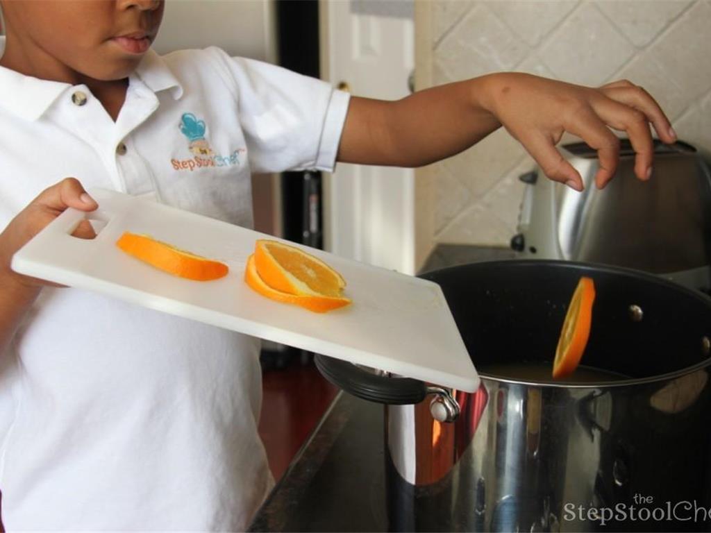 Step 2 of Orange Apple Cider Recipe: Then add orange slices and Apple Cider (1 gallon) into a large pot.