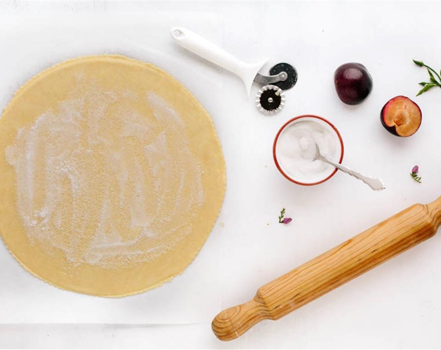 step 9 Unwrap and transfer it onto a lightly floured kitchen counter. Roll it into a 12-inch circle that is 0.15-inch thick. Trim the edges to a clean circle with a pastry cutter.