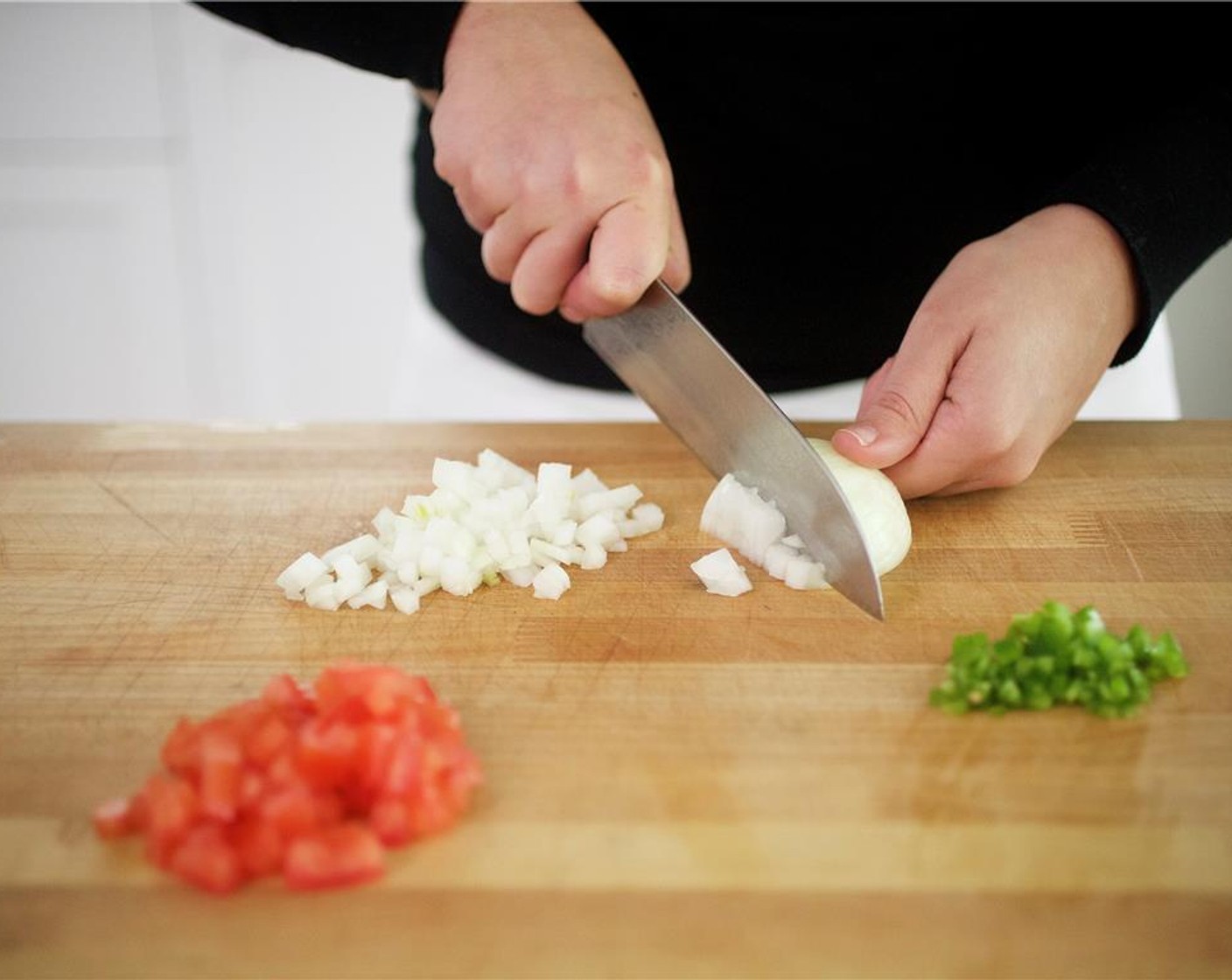 step 1 Cut larger Tomato (1) lengthwise into four wedges. Scoop out seeds and discard. Dice into quarter inch pieces and add to medium bowl. Remove stem and seeds from Jalapeño Pepper (1), mince, add add to bowl. Mince only half of the small Onion (1) and add to bowl.