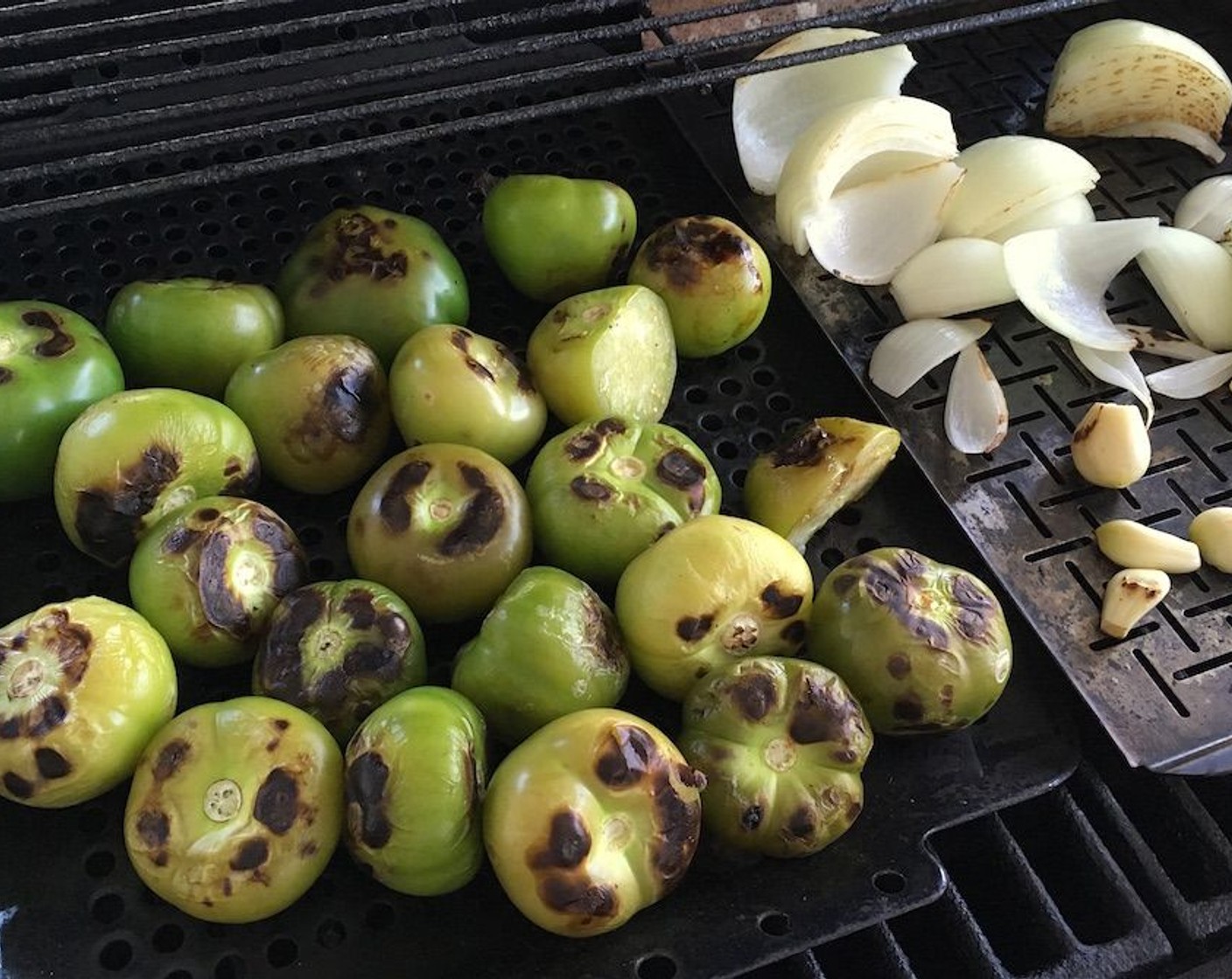 step 2 On a grill tray, grill the whole Tomatillos (3.5 lb), Onion (1) and Garlic (4 cloves) over medium heat until they soften and brown slightly.