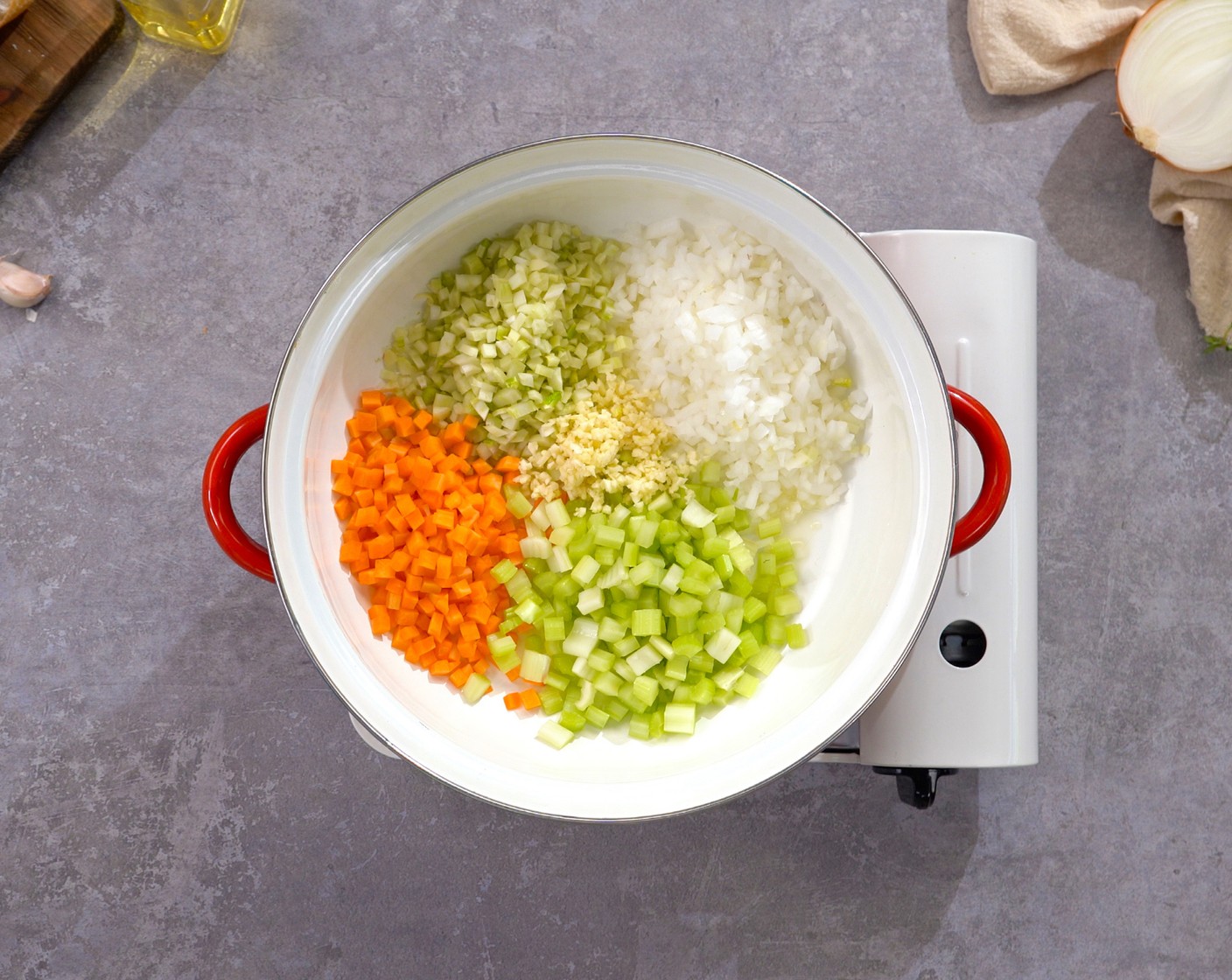 step 2 In a large pot, heat the Olive Oil (2 Tbsp) over medium heat. Add Yellow Onion (1), Fennel Bulb (1), Carrot (1/2), Celery (1 stalk), and Garlic (4 cloves). Sauté until the vegetables are soft, about 3 minutes.