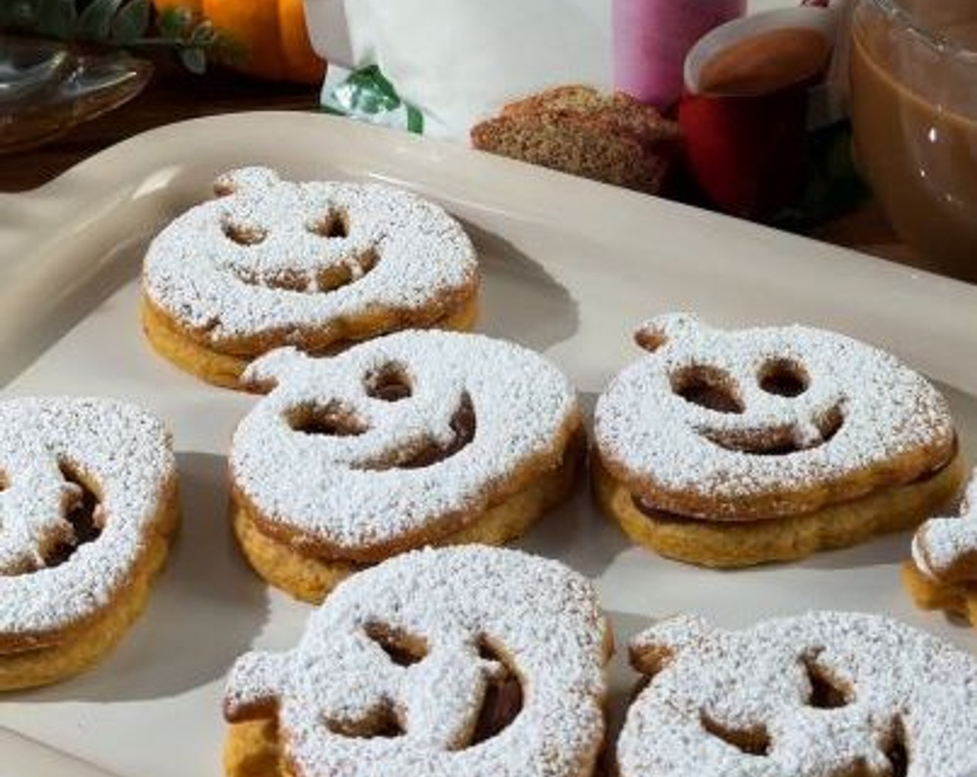step 12 Spread ganache on cookies without faces, then top with jack-o-lantern cut-out cookies to form sandwiches. Dust lightly with Truvia Sweet Complete® Confectioners Stevia Leaf Sweetener (1 Tbsp) and serve.