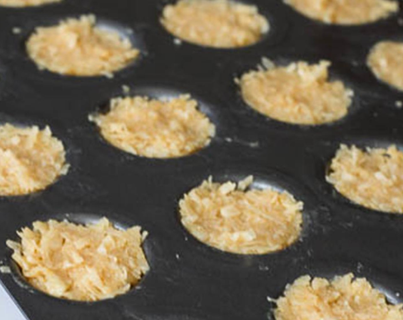 step 4 Lightly spray mini muffin pan with Nonstick Cooking Spray (as needed). Divide the coconut mixture into 24 mini cups packing them down tightly. Bake for 8-10 minutes, or until the edges are nicely browned.