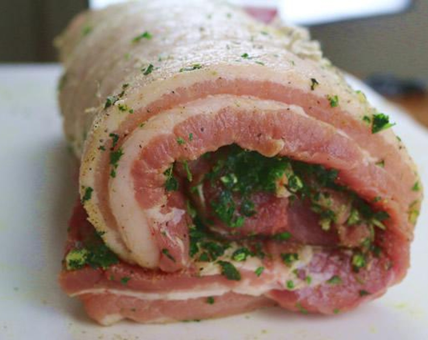 step 5 Wrap the pork belly around the pork tenderloin and secure with butcher twine in multiple locations. Make sure the twine is tight and spread out about 1inch apart. The result should be an even-sized Porchetta Roast.