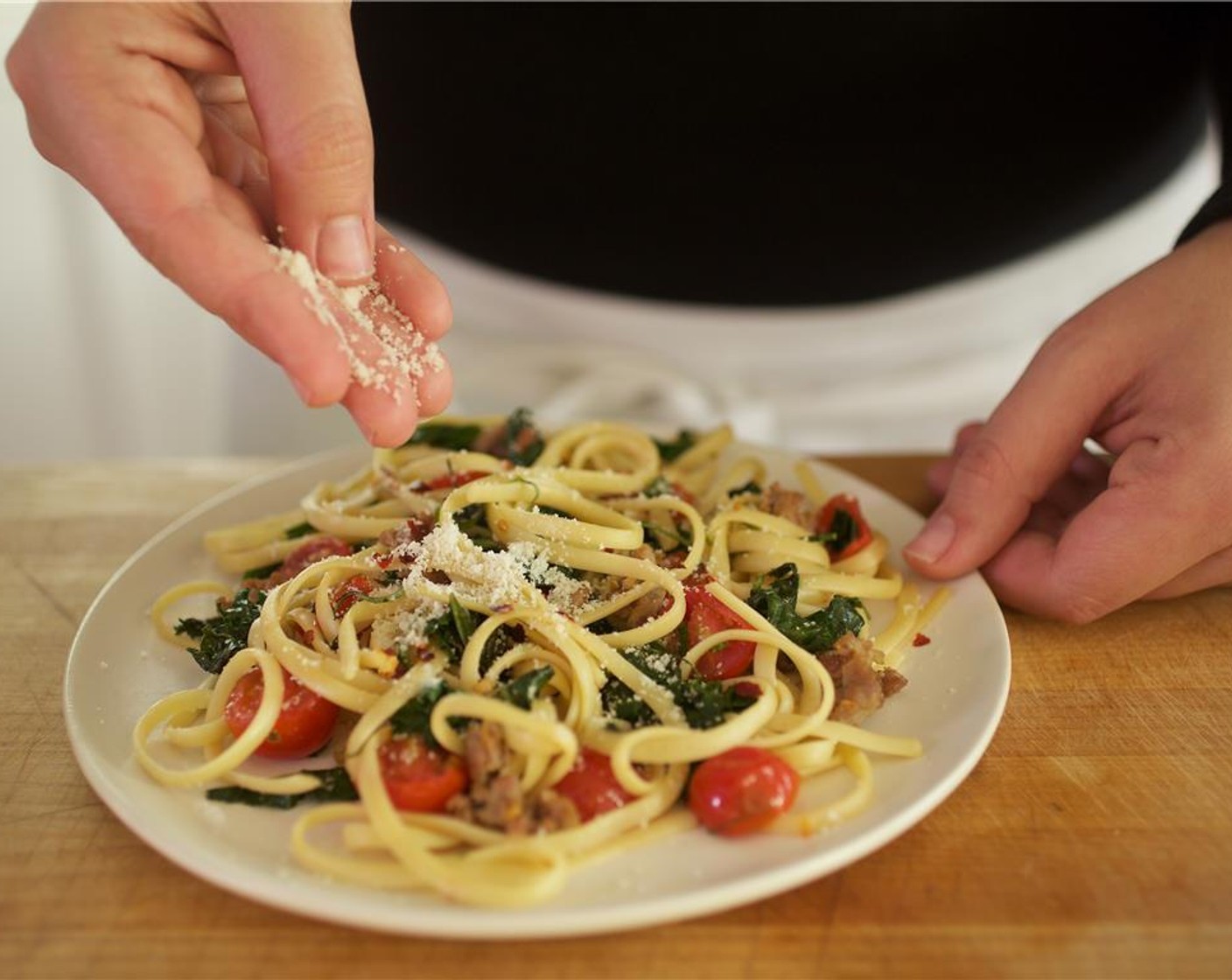 step 9 Distribute pasta evenly in the center of two plates. Sprinkle with Crushed Red Pepper Flakes (1/4 tsp) and Parmesan Cheese (1 tsp).