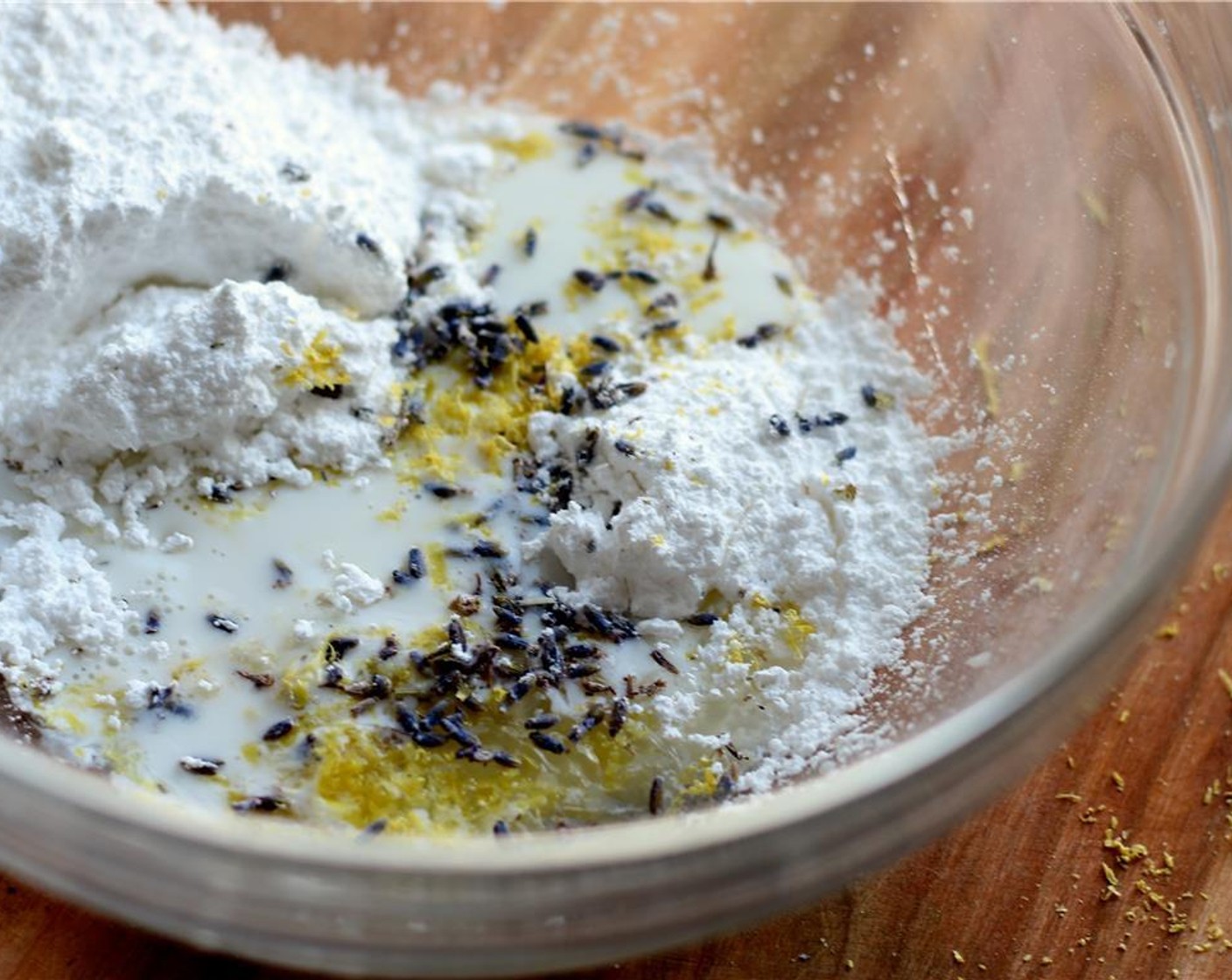 step 9 Let the madeleines cool on a wire rack while you prepare the glaze. In a bowl, whisk together the Powdered Confectioners Sugar (1 cup), Milk (1 Tbsp), 1 Tbsp of Lemon Zest, Dried Lavender Bulbs (1/2 tsp) and 1 Tbsp of Lemon Juice.