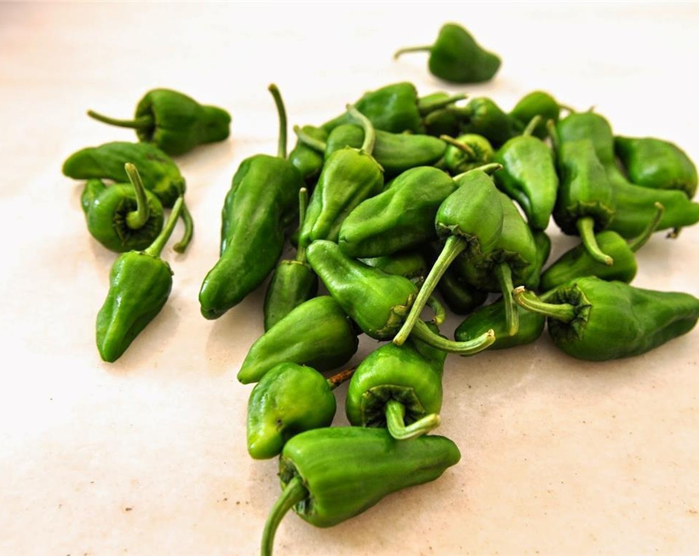 step 1 Halve the Padrón Peppers (4).