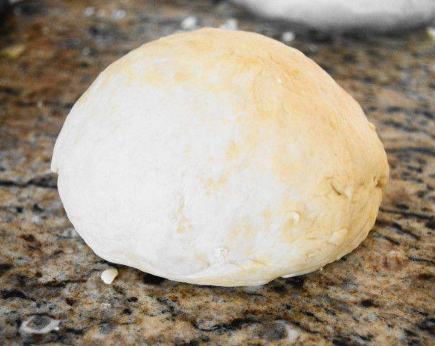 step 3 Form the dough into a ball and turn it out onto a lightly floured surface. Knead the dough for about 2-3 minutes to make it smooth and uniform.