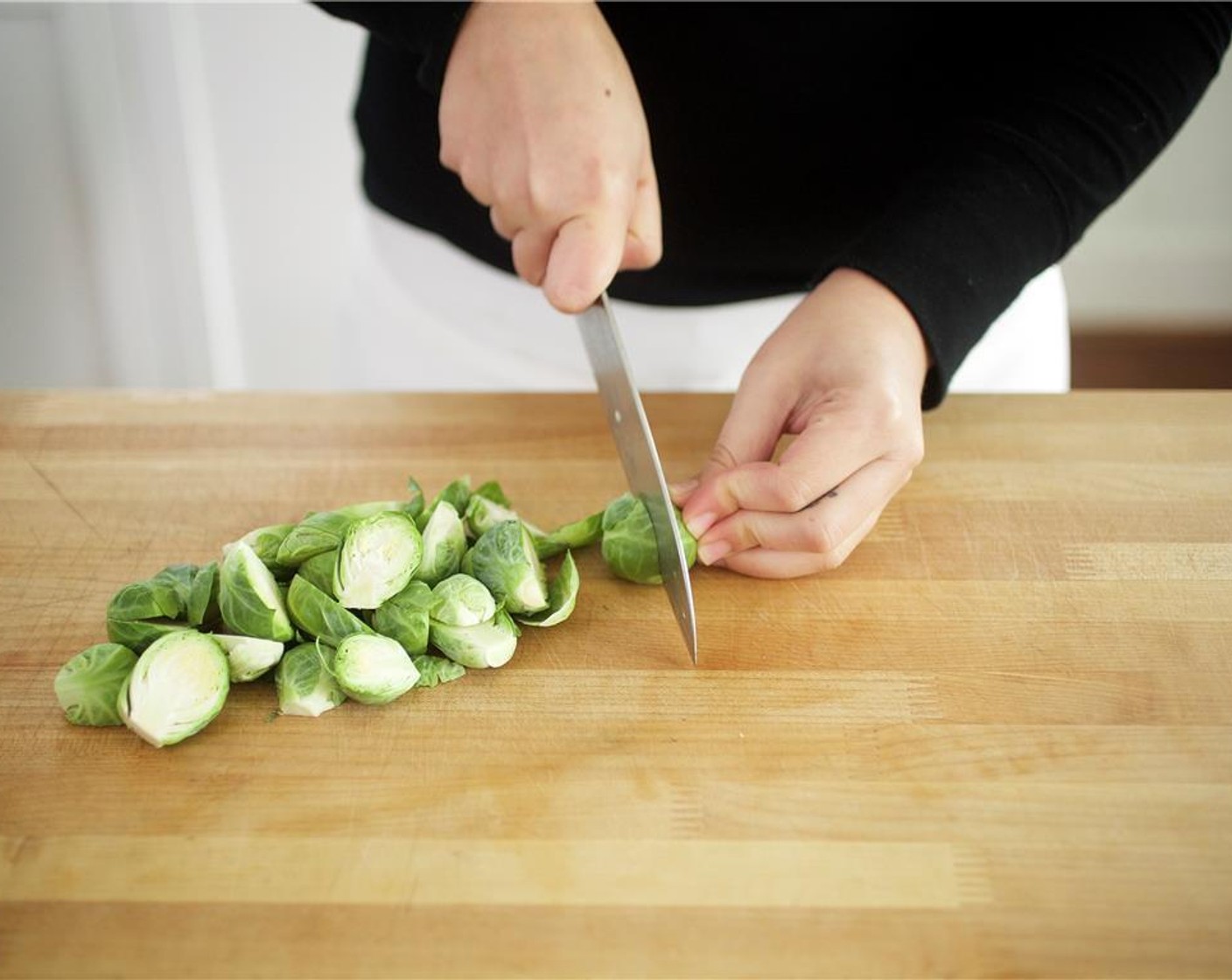 step 3 Trim the bottom of the Brussels Sprouts (2 1/2 cups) and slice in half lengthwise.