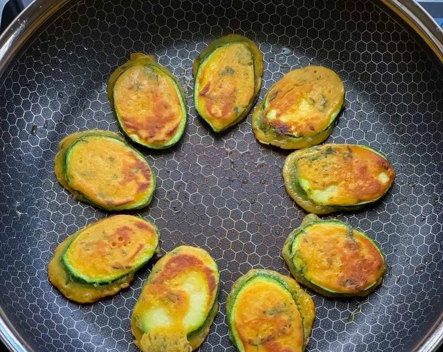 step 9 Flip the zucchini fritters to the other side once little brown from bottom and let them get crisp from other side. Nice golden brown color means fritters are cooked.