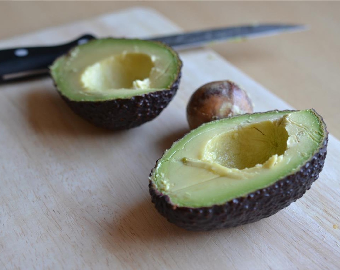 step 2 Cut the Avocado (1) in half, pit it and remove the flesh of the avocado. Peel the Garlic (1 clove).