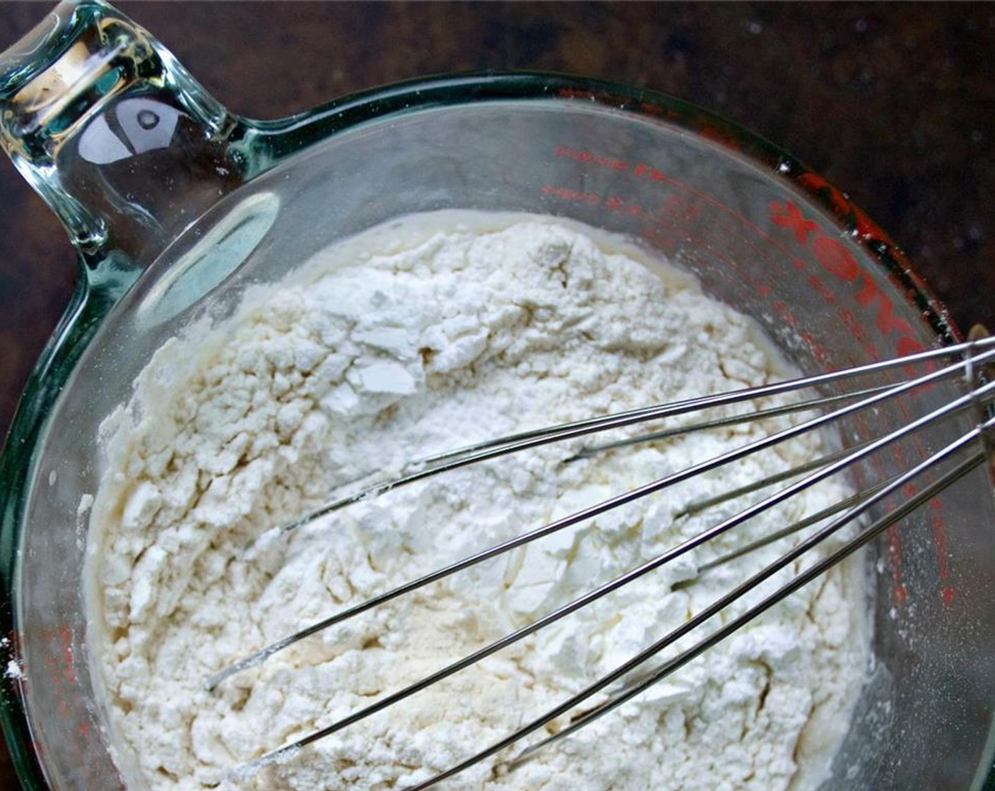 step 4 For pancakes, whisk All-Purpose Flour (1 cup), Baking Powder (1/2 Tbsp), and Salt (1/2 tsp) together in a large mixing bowl. Add Coconut Milk (1 cup), flaxseed egg, and Coconut Oil (1 Tbsp). Mix until just combined.