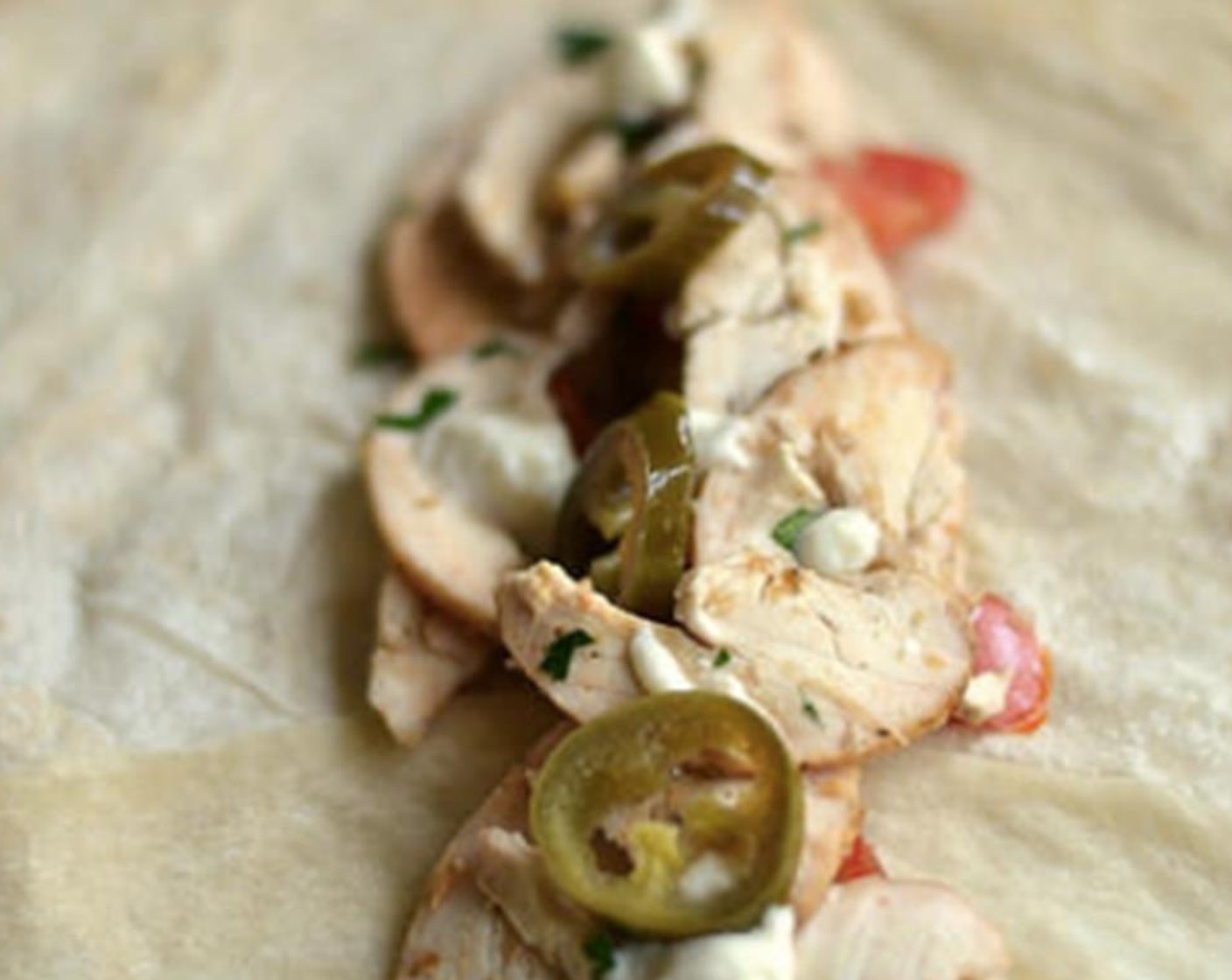 step 7 Spread a thin layer of Garlic Mayonnaise (to taste) on Flour Tortillas (to taste) and add chicken mixture, Fresh Parsley (1 Tbsp), and Pickled Cucumbers (to taste).