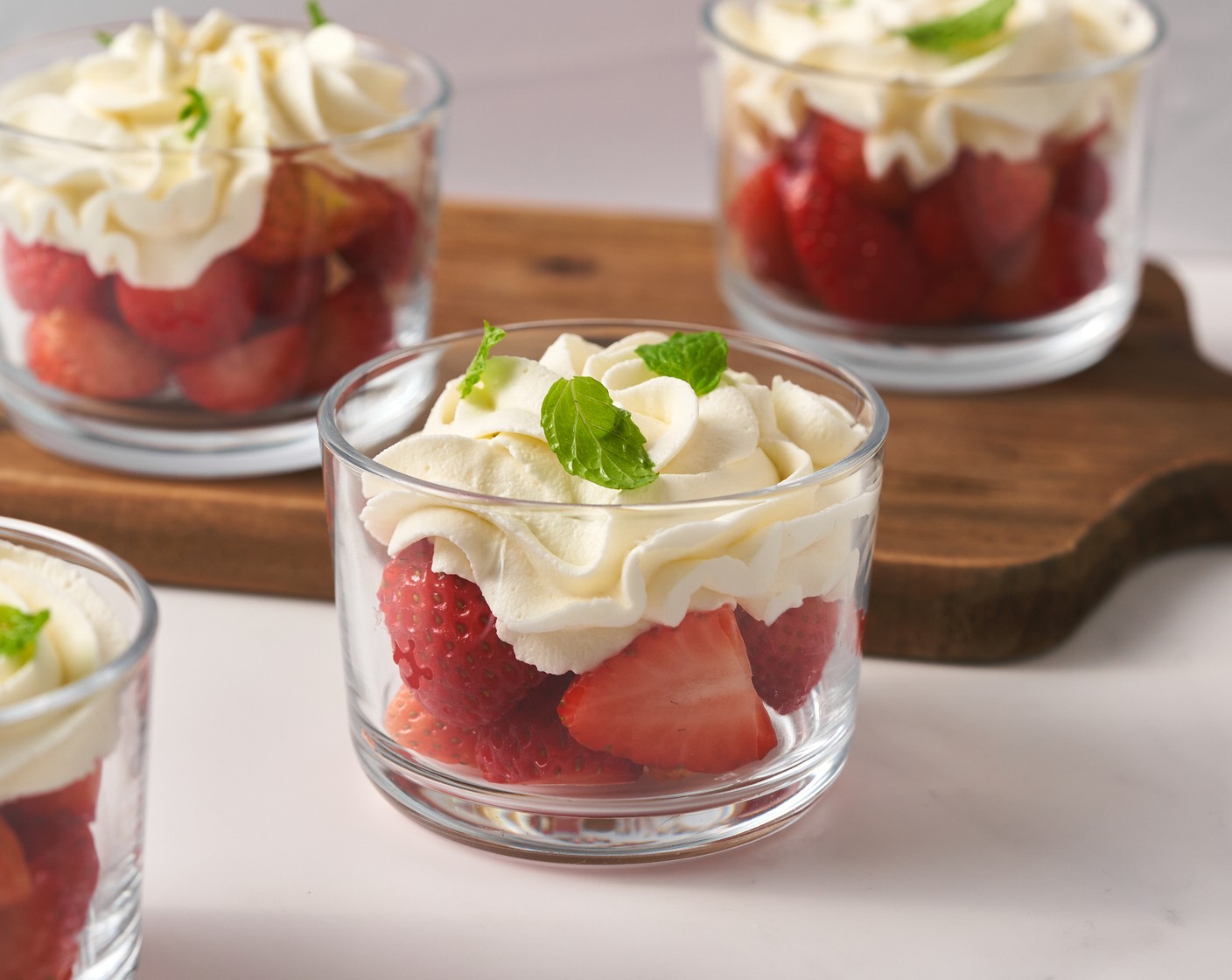 step 6 Spoon with the Fresh Strawberries (3 cups) and alternate between layers of strawberries and cream. Garnish with extra mint leaves on top.