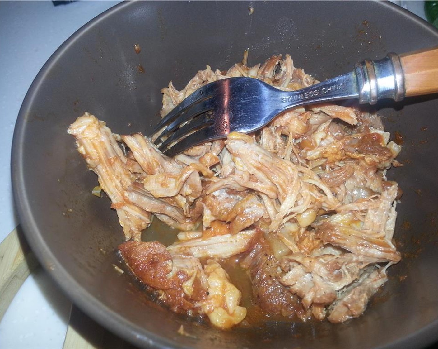 step 17 Shred the pork shoulder with forks or a pair of clean hands.