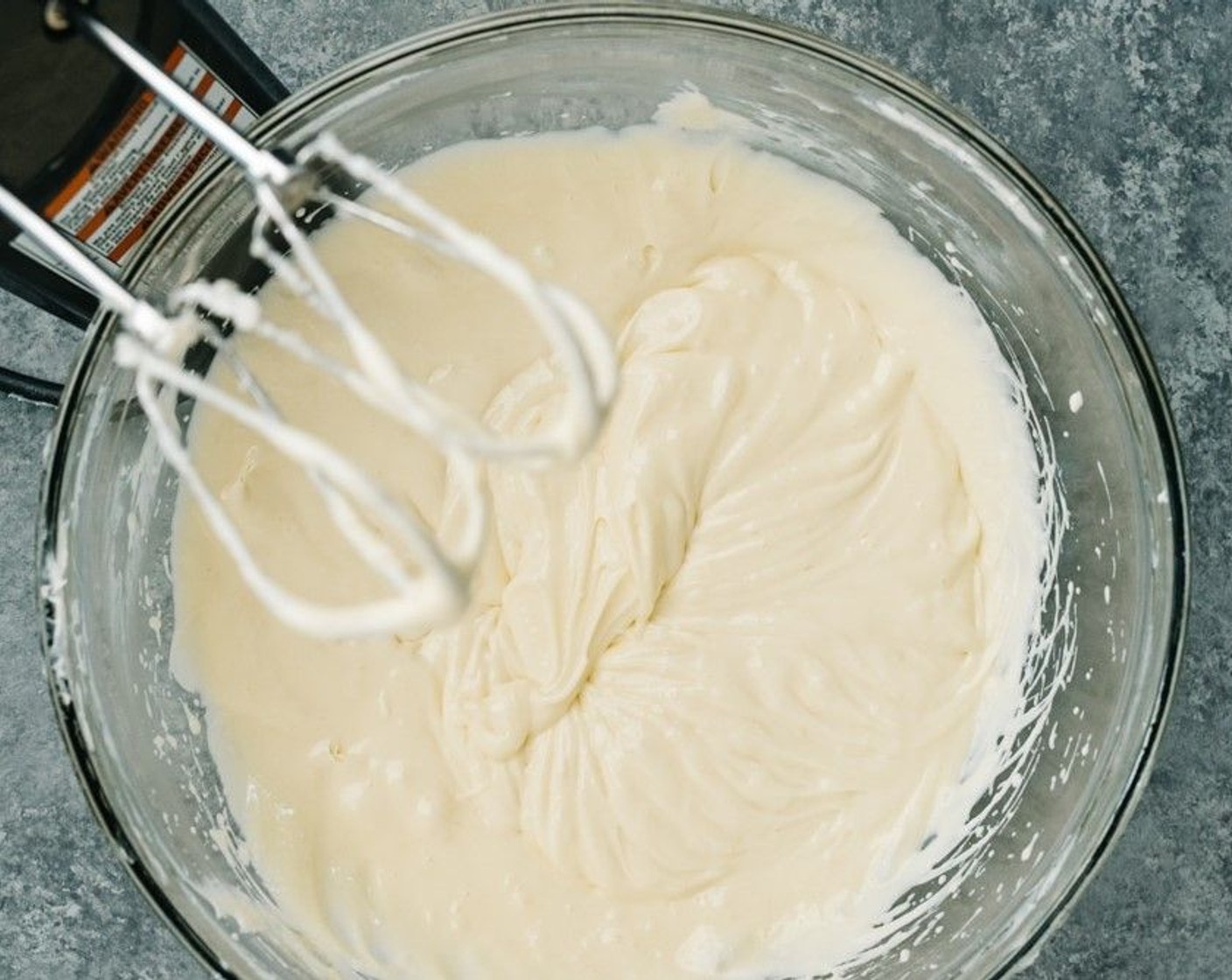 step 6 Add Philadelphia Original Soft Cheese (2 pckg), Granulated Sugar (3/4 cup), Vanilla Extract (1 tsp), and juice from Lemon (1) to a large mixing bowl and use an electric mixer to beat the cream cheese and sugar together until smooth. Scrapes the sides of the bowl as needed.