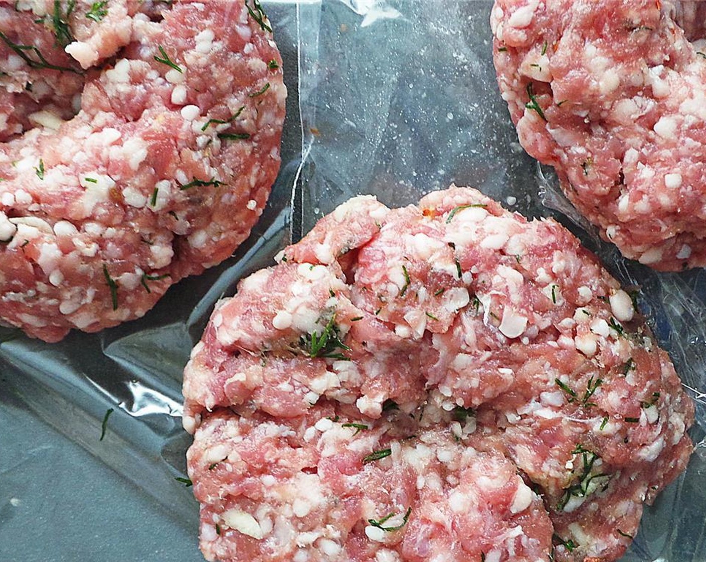 step 3 Scoop a fourth of the meat and form it into a burger. With your thumb, make an indent on the top of the patty. Transfer to a plate and repeat for the next three patties. Place the patties in the fridge for 30 minutes to one hour.