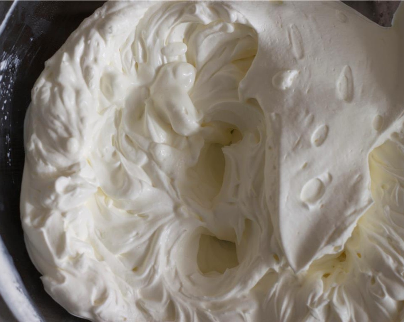 step 2 In a large, chilled bowl, use a hand mixer to beat the  Heavy Cream (1 1/2 cups)  until thick and creamy. On low speed, beat in the Dark Cocoa Powder (1/2 cup) ¼ cup at a time, and add in the Vanilla Extract (1 tsp).