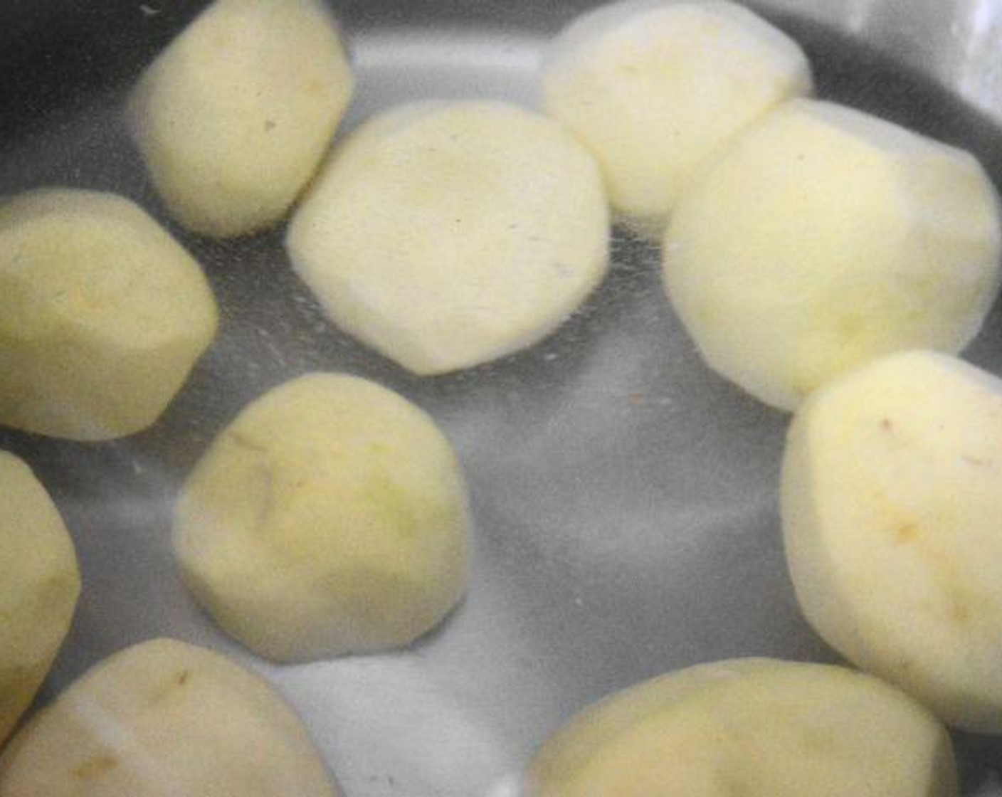 step 1 Get a large pot of water on the stove, then add the Yukon Gold Potatoes (10) and a big pinch of Kosher Salt (1 pinch) to it. Bring the pot to a boil and let the potatoes cook until tender for about 20-25 minutes.