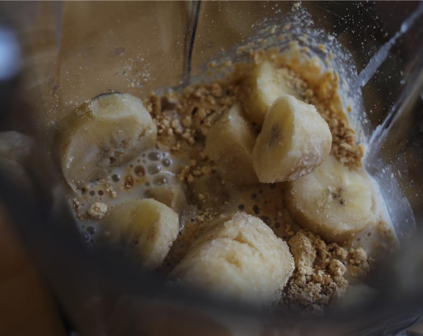 step 1 In a blender, add Almond Milk (1/2 cup), Banana (1), Peanut Butter (2 Tbsp), and Vanilla Whey Protein Powder (1/4 cup).