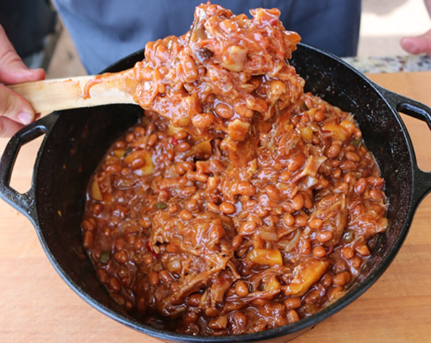 step 7 Pour the Baked Beans (6 1/4 cups) into a dutch oven iron pot. Add the apple mixture, Pulled Pork (1 lb), bacon, Barbecue Sauce (8 oz), Dijon Mustard (1 Tbsp), Brown Sugar (1/2 cup), Barbecue Rub (3 Tbsp), and All-Purpose Spice Rub (1 Tbsp). Stir to combine and place uncovered on the BBQ grill.