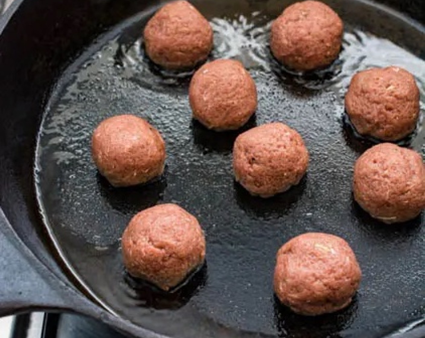 step 5 Carefully place the meatballs in the skillet, leaving adequate space between each meatball. Add 8 to 10 meatballs to the skillet at a time. Leave meatballs untouched for about 2 minutes to allow the meatball to properly sear before turning them over.