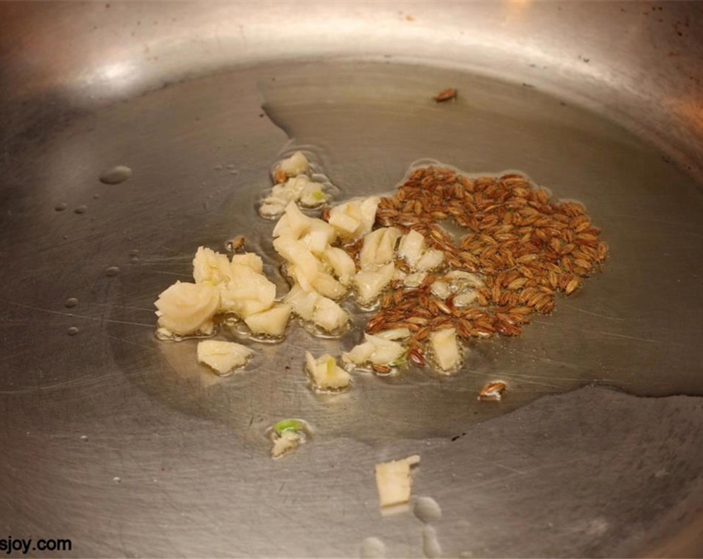 step 2 Heat Olive Oil (1 tsp). Add Cumin Seeds (1 tsp) and Garlic (2 cloves) and sauté for a few seconds.